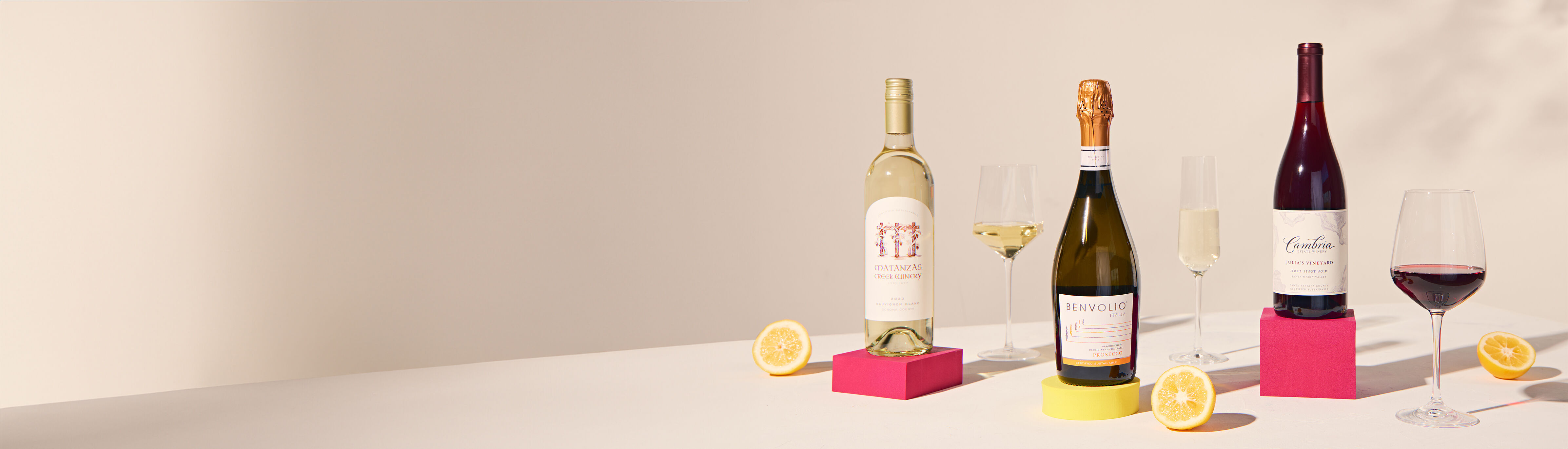 bottle of wine with glasses and lemon slices